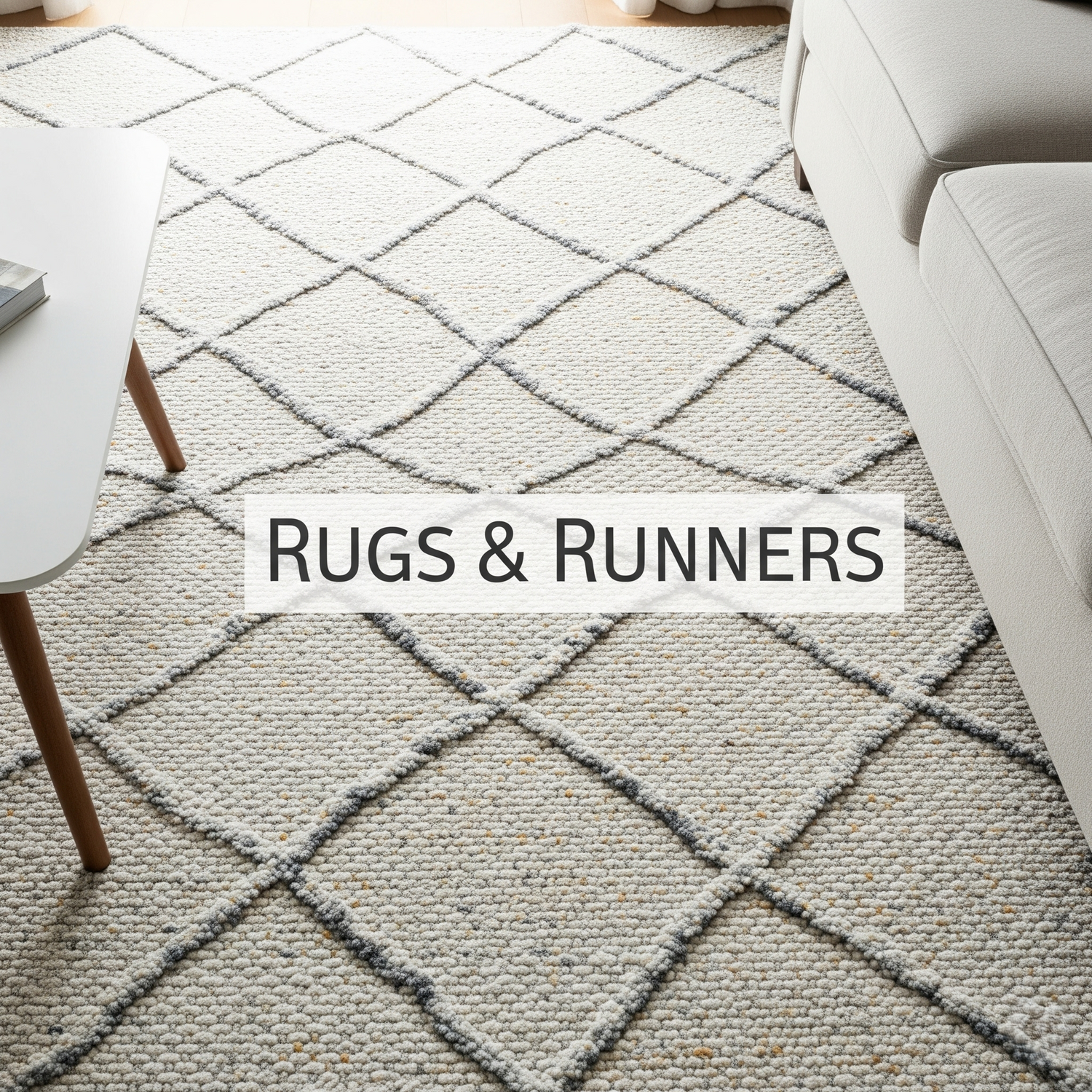 An overhead view of a textured rug in a living room, partially showing a sofa and table.