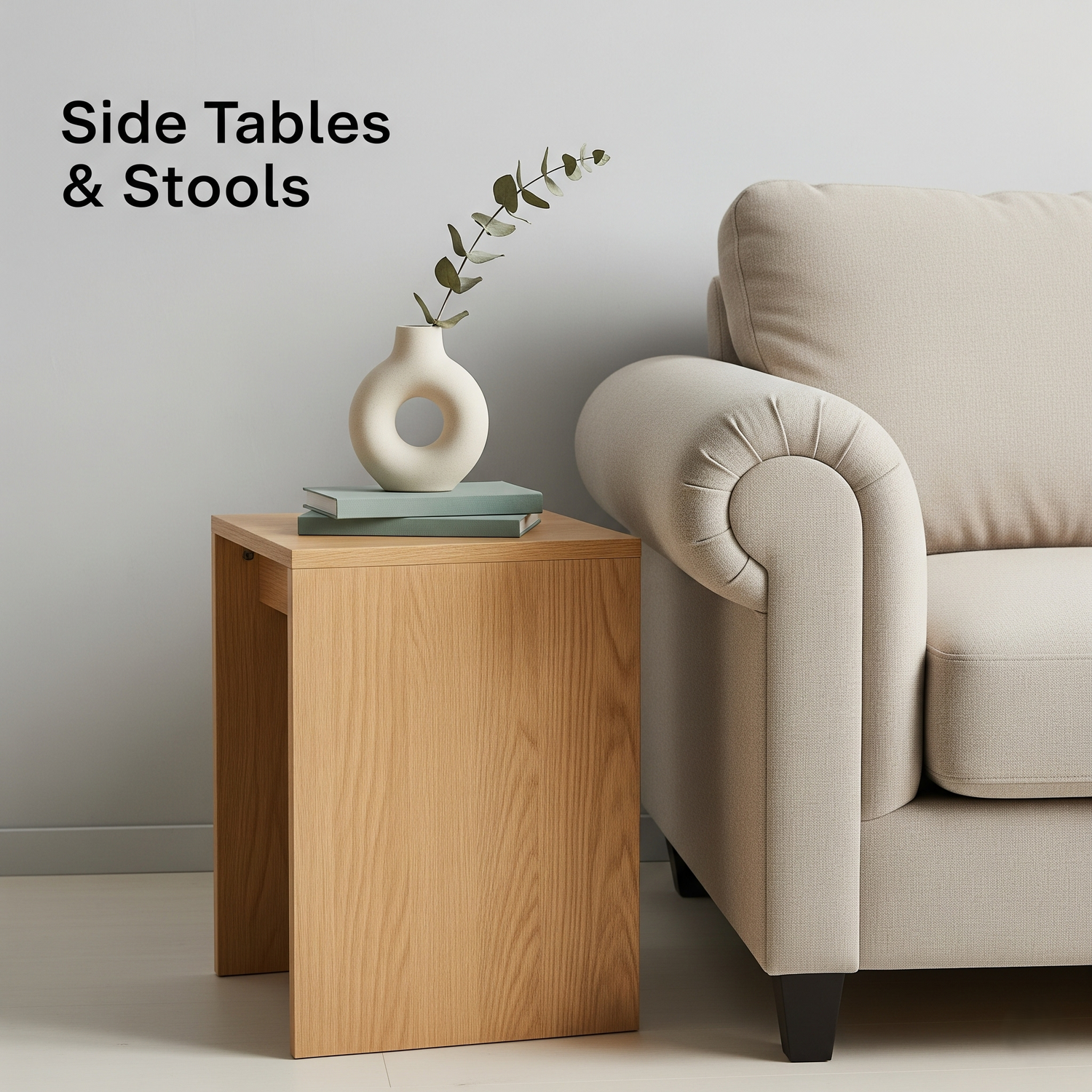 A side table next to a sofa with a vase and minimal decor.